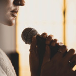 woman singing a worship song about trusting God in hard times