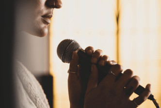 woman singing a worship song about trusting God in hard times