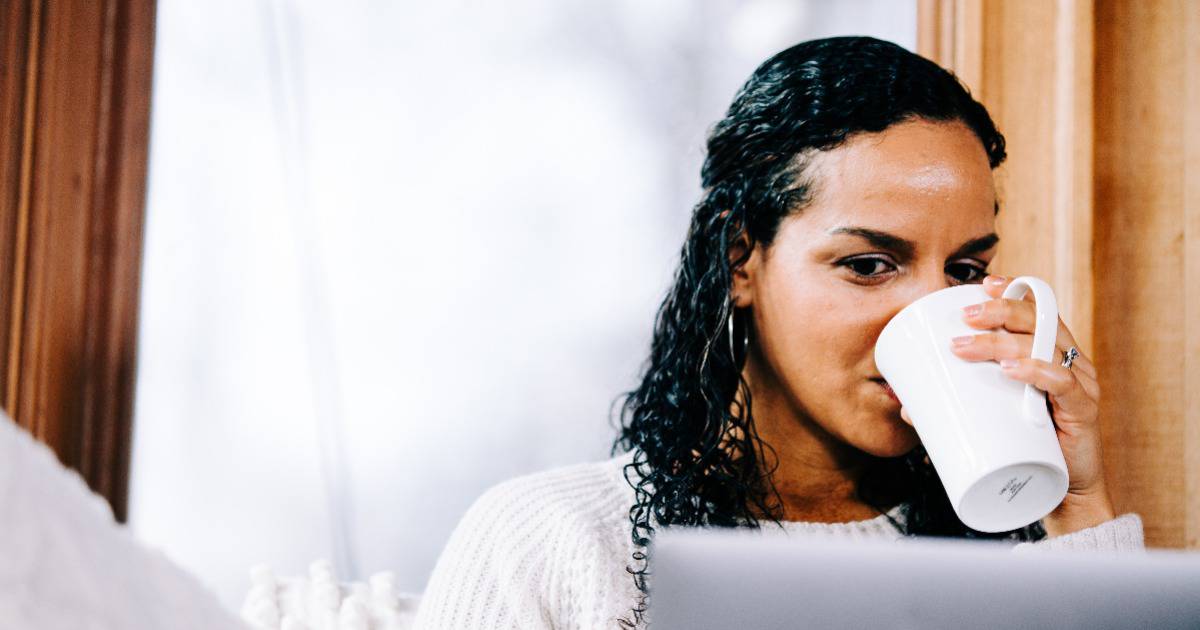 woman on couch looking through ministry resources hub
