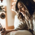 woman looking at a church's social media at Christmas